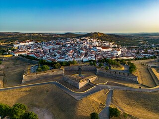 Drone shot of the Elvas castle in Portugal with residential buildings on its background
