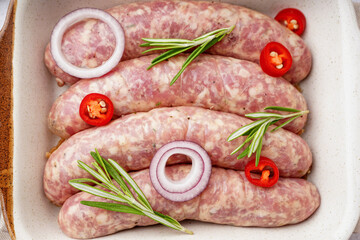 Raw homemade sausages in baking dish, closeup