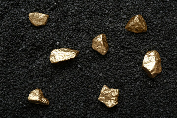 Fototapeta premium Golden nuggets on black coal