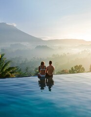 Couple watching charming mountain views from a water pool villa, Indonesia