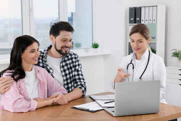 Fototapeta premium Couple having appointment with fertility doctor in clinic. Patient consultation