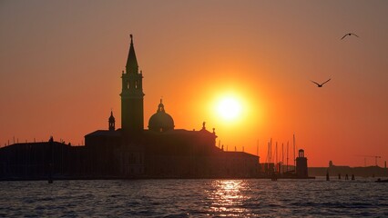 Fototapeta premium Silhouette shot of a building and a tower located on San Giorgio Maggiore island
