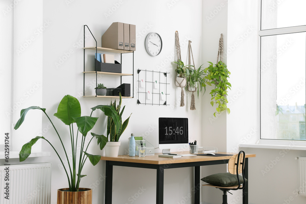 Canvas Prints Cozy workplace with computer, modern furniture and houseplants at home