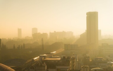 Fototapeta na wymiar Misty golden sunrise in a metropolis