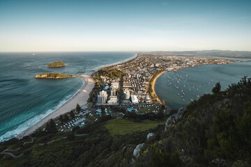 Fototapeta premium Drone shot of a city on the coast of a sea under the blue sky