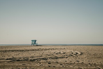 Blue guard post on the sandy Huntington Beach in California