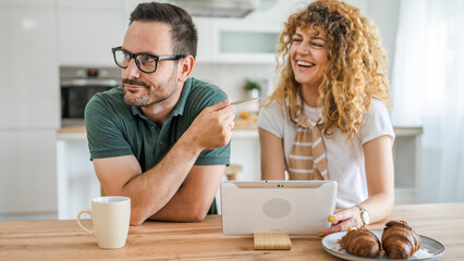 adult couple man and woman shopping online use laptop hold credit card