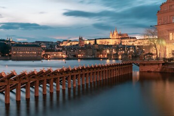 St. Vitus Cathedral with the Charles bridge at sunset in Prague by night