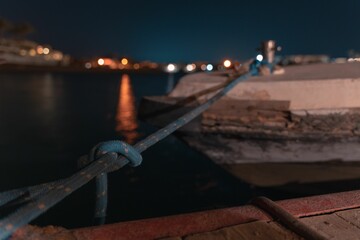 Long-time exposure of a boat in El Gouna lagoon on a view of the illuminated city at night