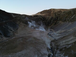 Aerial view of steam from a flowing stream in the mountains of Reykjadalur, Iceland