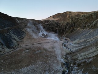 Aerial view of steam from a flowing stream in the mountains of Reykjadalur, Iceland