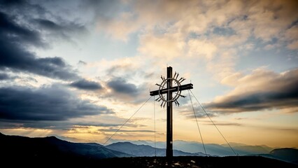 Fototapeta na wymiar Beautiful shot of a large cross sculpture on a hill at sunset in Tyrol