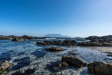 Beautiful view of a rocky sea under the clear sky during sunrise
