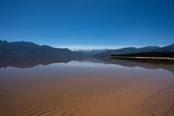 Scenic shot of the Theewaterskloof dam with the reflection of surrounding hill on its surface