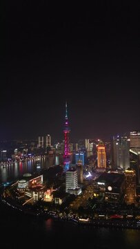 Aerial of the illuminated Oriental Pearl TV Tower in Shanghai agains the black night sky