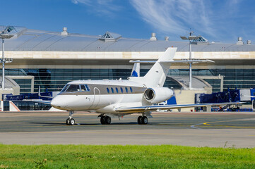 The business jet moves along the airport apron. Takeoff preparation. Jet business aviation or private aviation