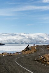 Vertical shot of a curvy road in winter.