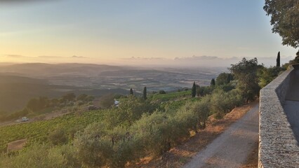 Sunset view from a high point over terrain landscape in a mist