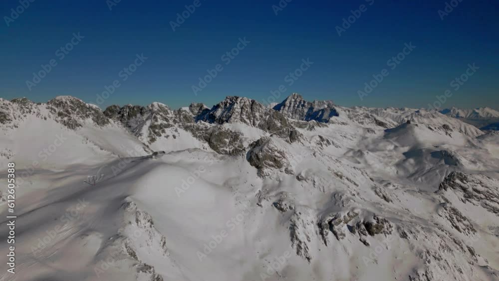 Sticker Beautiful footage of Snow covered snowy hill and blue sky in the winter