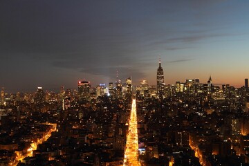 Drone view of the cityscape of New York City with many buildings and skyscrapers at night in the USA © Jerry56/Wirestock Creators