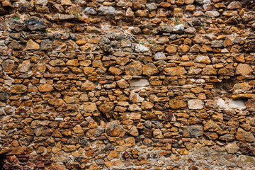 Old antique natural stone background, textured masonry walls of ancient fortifications