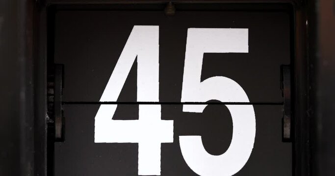 4K footage close-up front view, Fig clock white number 45 on a black background.
