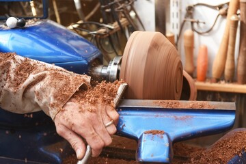 Closeup view of the process of making a wooden bowl on a woodturning machine