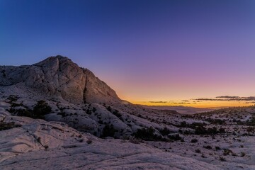 Scenic view of a desert at night with pink sky in the evening in the background