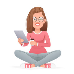 Happy girl in glasses sits cross-legged with a tablet and a glass of coffee in her hands. Beautiful white slender woman sits in a lotus position