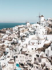 Fototapeta na wymiar Beautiful cityscape of the white buildings of Santorini under the clear blue sky in Greece