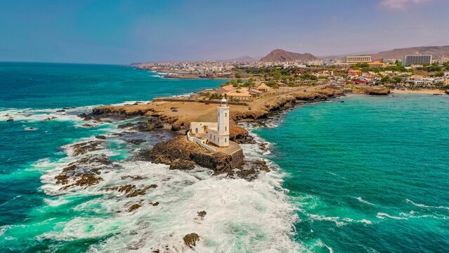 Aerial view of the shore of Praia de Santiago and the Praia lighthouse on a sunny day