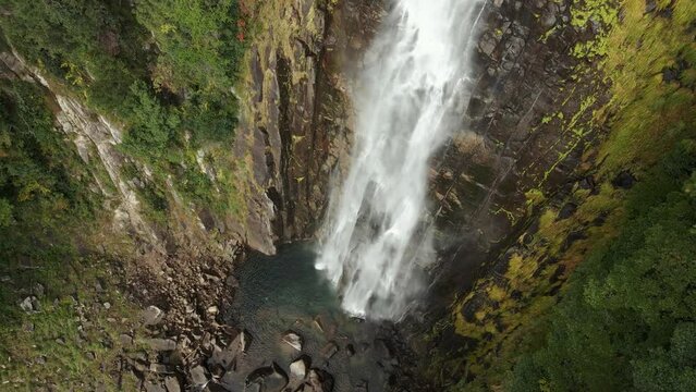 Drone shot over the Nachi falls flowing over the cliffs, Japan