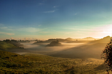 Fototapeta premium foggy fields and blue sky