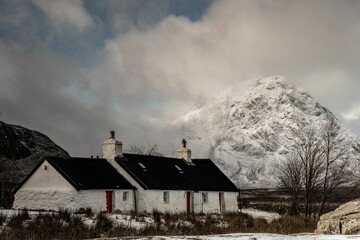 Aerial view of snow covered mountain landscape with black and white building