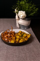 Dishes of different foods served in an elegant and striking way inside a restaurant