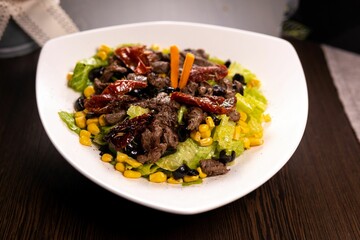 food is on a white bowl and placed on a table