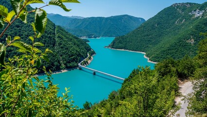 High-angle of a nice view above the Pluzine lake and bridge, Montenegro - obrazy, fototapety, plakaty