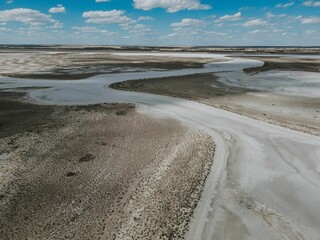 Aerial video of a dry empty field on a sunny day with unique patterns made by nature