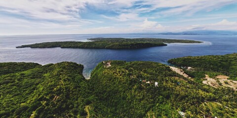 Aerial shot of the Nusa Penida island in Indonesia surrounded by the blue sea waters