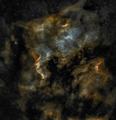 A nebula with dark smoke and stars in a vast glimmering galaxy sky