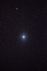 Tranquil nighttime scene of a twinling star in a dark cosmic sky