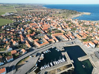 an aerial shot of an old marina and small town by the water