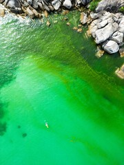Aerial view of lush green sea waters winding through rocky formations, perfect for wallpapers