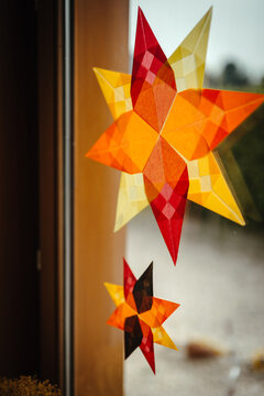 Autumn waldorf paper stars stuck on the window