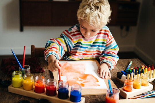 Lovely kid engrossed in painting