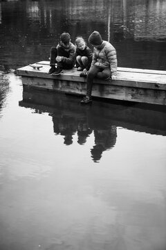 children sit on a dock