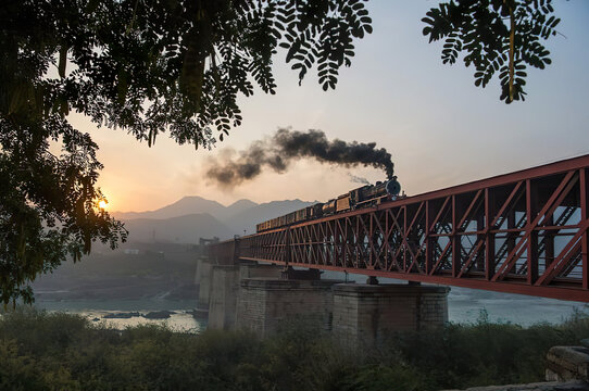 The bridge is traversed by a steam train.
