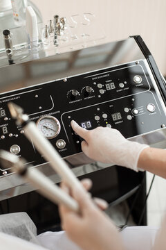 Hand of woman in gloves pressing the button of device