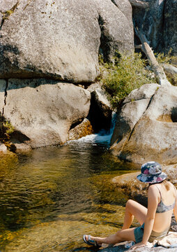 Woman Sitting at Swimming Hole