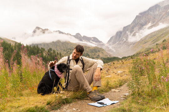 Man and dog Checking Map

